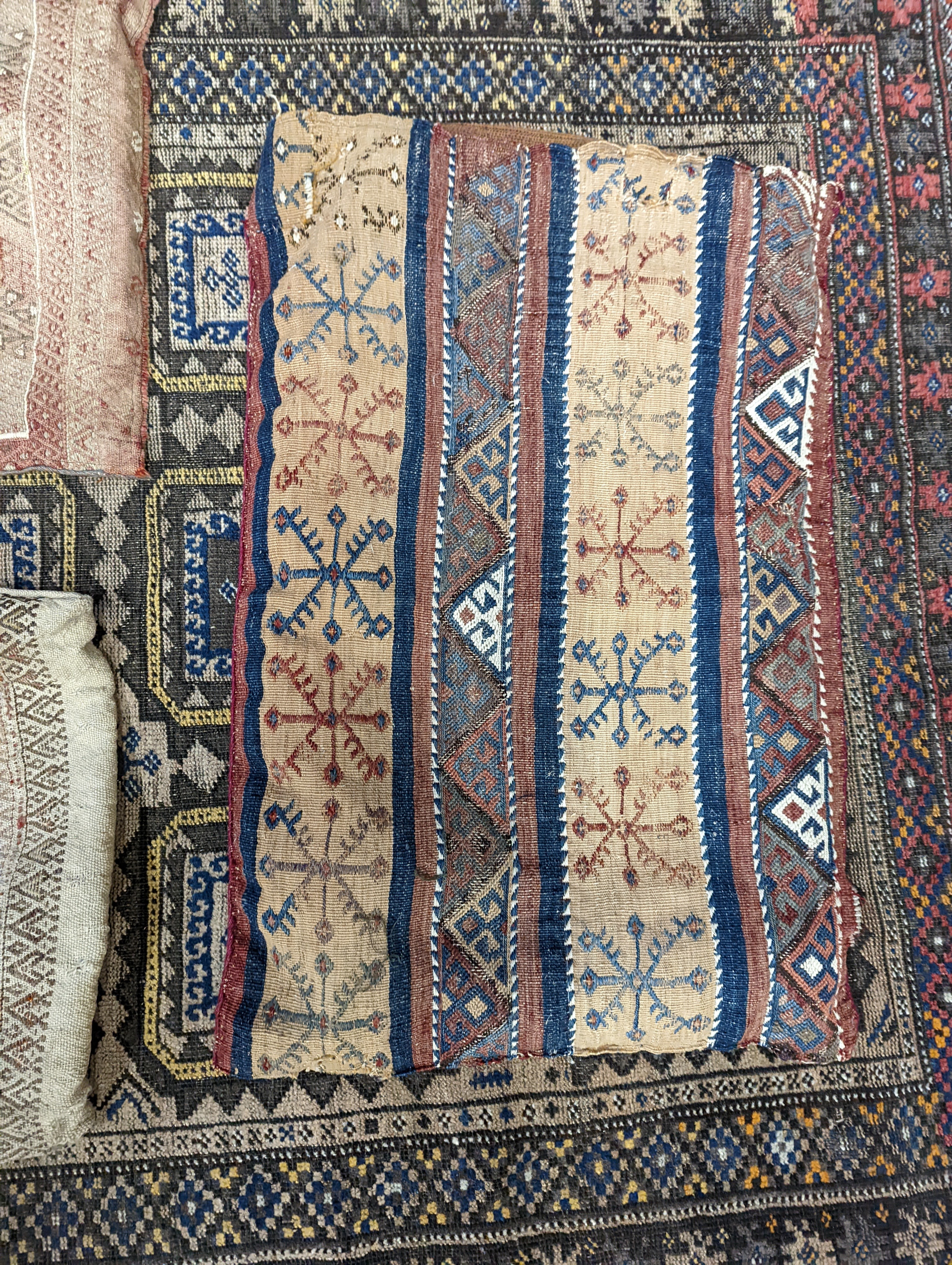 A Belouch geometric rug, 216 x 130cm. together with four Kelim cushion covers